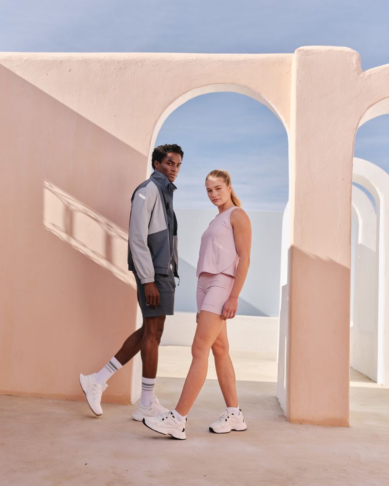TWO MODELA, MALE AND FEMALE STANDING WEARING ACTIVE WEAR
