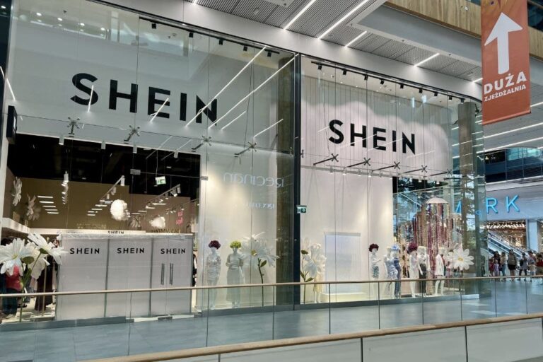 Shein storefront in Paris with protest signs outside following legal suspension hearing in France.
