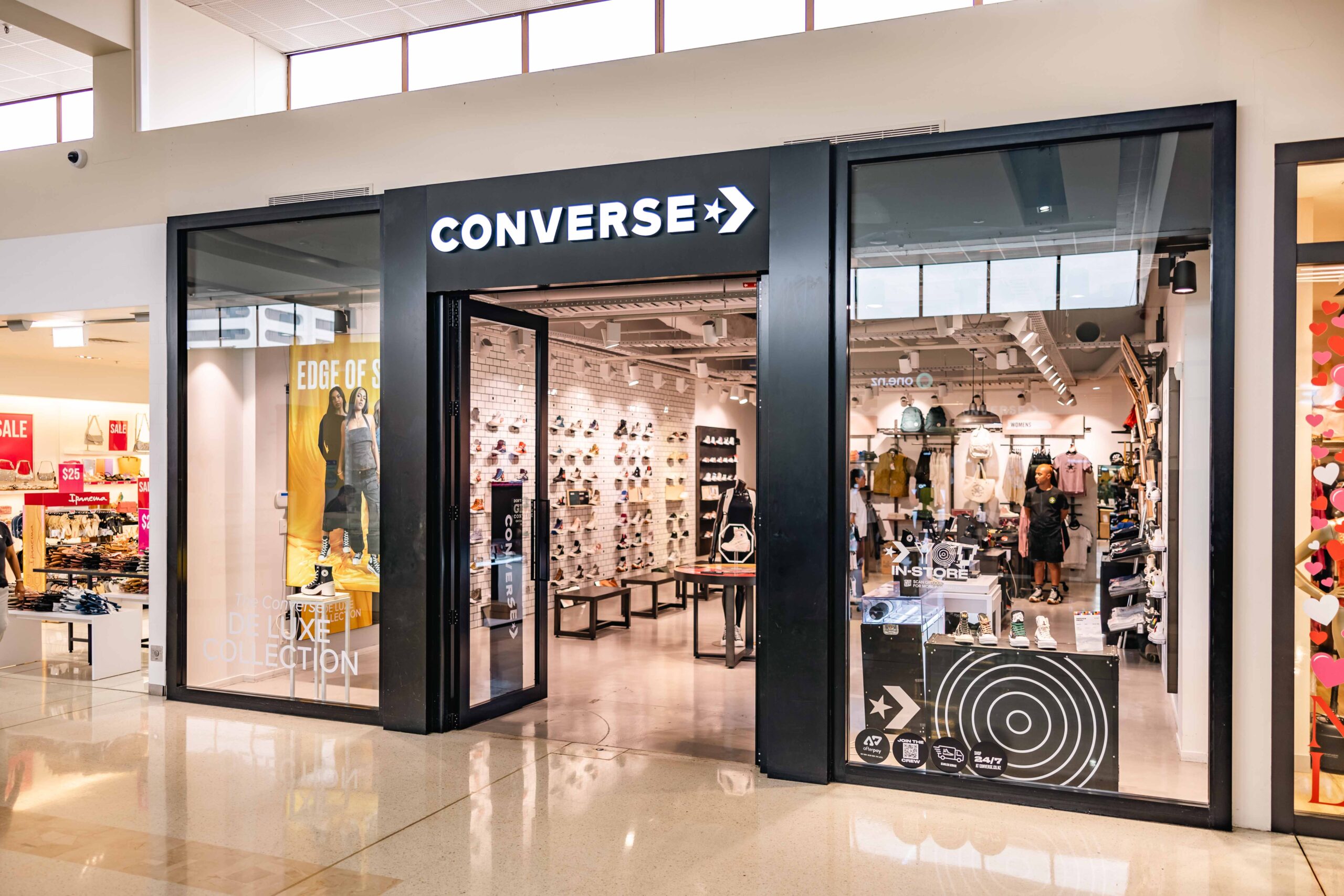 Converse Chuck Taylor sneakers displayed in a retail store amid declining sales and increased discounting under Nike ownership.