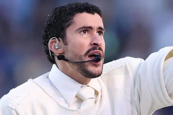 Bad Bunny performing at the Super Bowl halftime show wearing a custom neutral-toned Zara outfit inspired by Spanish heritage.